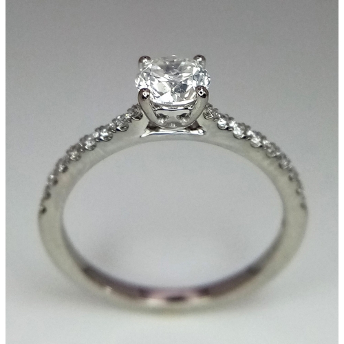 514 - A 950 Platinum Diamond Ring. Brilliant round cut central SI2 diamond - 0.53ct. 0.17ctw diamonds on s... 