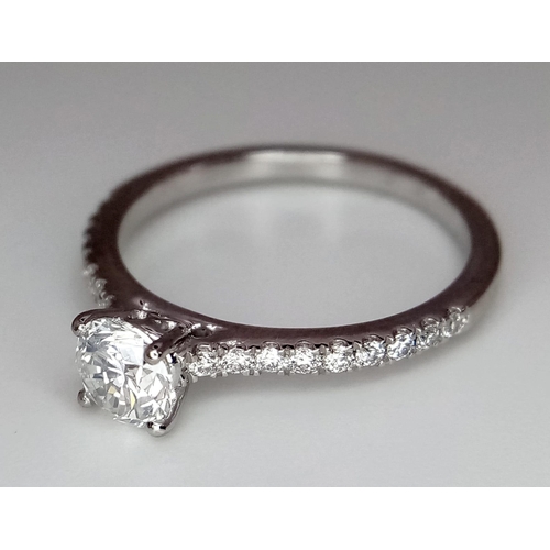 514 - A 950 Platinum Diamond Ring. Brilliant round cut central SI2 diamond - 0.53ct. 0.17ctw diamonds on s... 