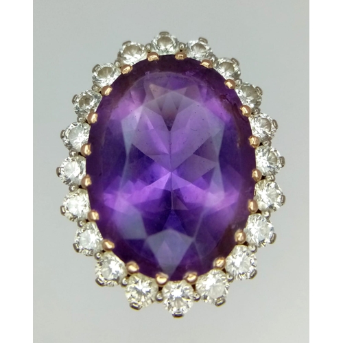 55 - AN 18K YELLOW GOLD DIAMOND & PURPLE STONE ( BELIEVED TO BE AMETHYST ) COCKTAIL RING, WITH A LARGE FA... 