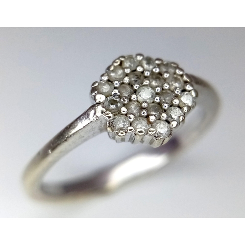 1031 - A 9k white gold diamond cluster ring. 2.5g total weight. Size N. (dia: 0.20ct).