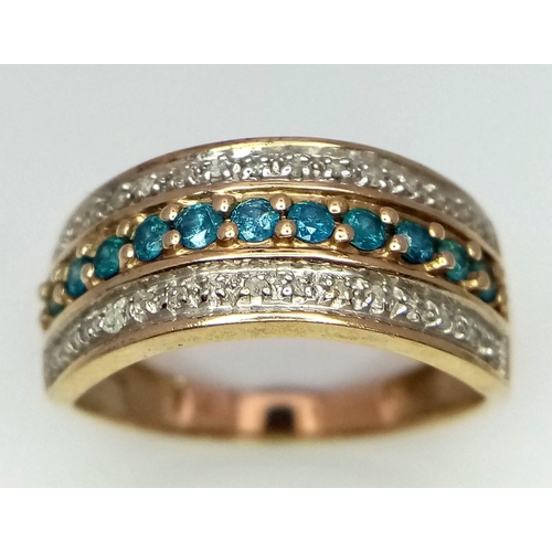 384 - A 9k yellow gold diamond and topaz wide band ring. 2.8g total weight. Size P (dia:0.30ct/topaz:0.44c... 