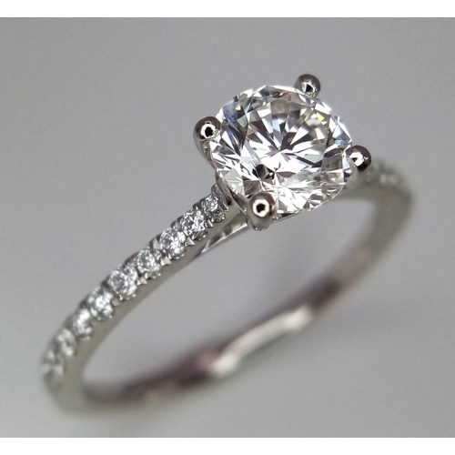 611 - A 950 Platinum Diamond Ring. Brilliant round cut VS1 diamond - 0.73ct with diamonds on shoulders - 0... 