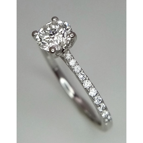 611 - A 950 Platinum Diamond Ring. Brilliant round cut VS1 diamond - 0.73ct with diamonds on shoulders - 0... 