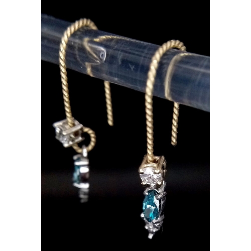 662 - A Pair of 14K Gold and Fancy Blue and White Diamond Earrings. 0.12ctw and 0.26ctw. 1g total weight.