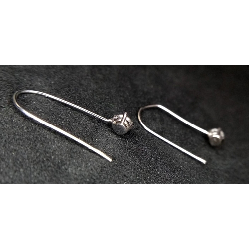 951 - A Pair of 14K White Gold and Diamond Drop Earrings. 2cm drop. 0.14ctw.