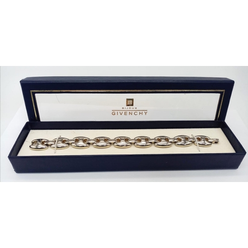 1003 - A Givenchy Silver Plated Bracelet. 18cm. In original packaging.