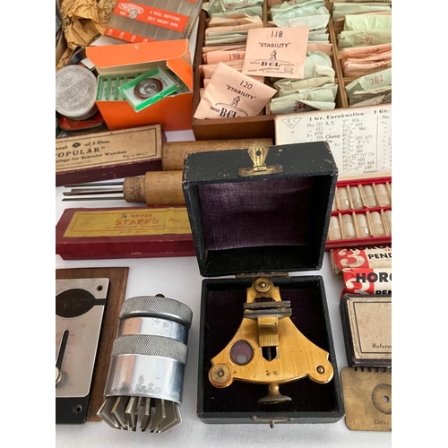 154 - The contents of a retired watchmaker/repairers work bench  to include a  Large quantity of watch gla... 