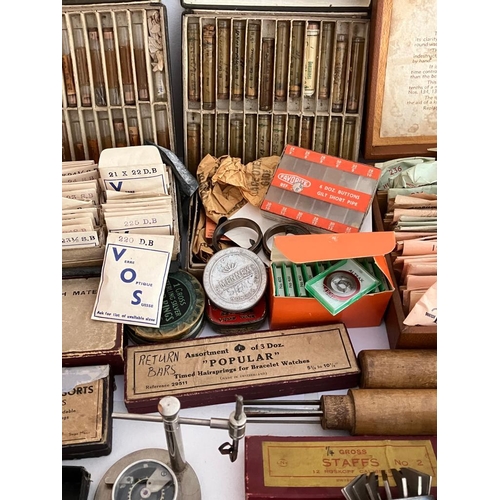 154 - The contents of a retired watchmaker/repairers work bench  to include a  Large quantity of watch gla... 