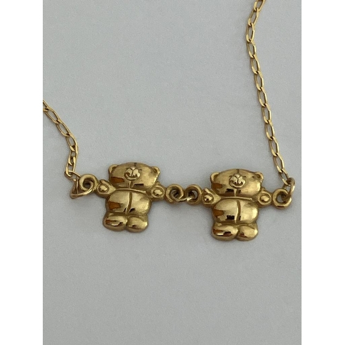 217 - 9 carat GOLD FINE CHAIN NECKLACE with 2 Gold teddy bears. 0.97 grams. 40 cm.