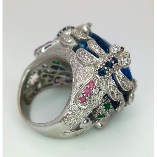 27 - An 18kt White Gold Exquisite Fancy Cocktail Ring Set with Diamonds, Rubies, Sapphires & Emeralds wit... 