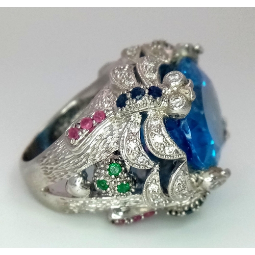 27 - An 18kt White Gold Exquisite Fancy Cocktail Ring Set with Diamonds, Rubies, Sapphires & Emeralds wit... 