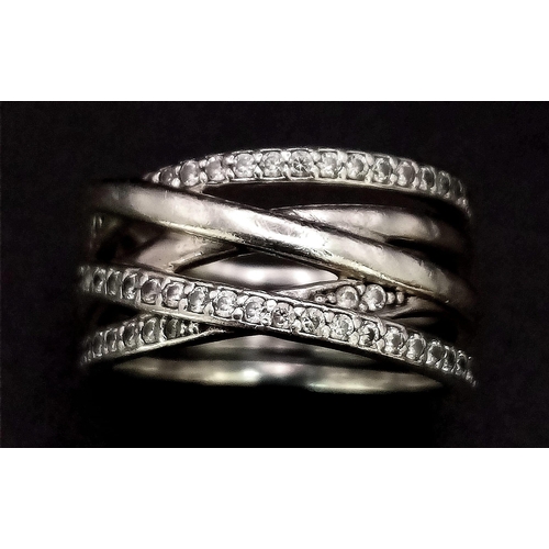 1161 - Sterling silver wavey stone set band ring. Wt 6.5g, size M/N.