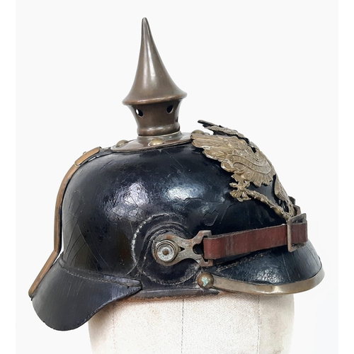 124 - An Imperial German/Prussian 1897 Pickelhaube with brown NCO’s chinstrap and cockades.