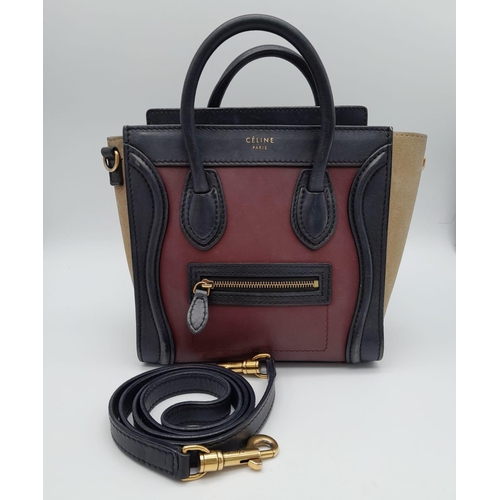 213 - A Celine Burgundy and Khaki Handbag. Crafted from a smooth burgundy leather and features a black lea... 