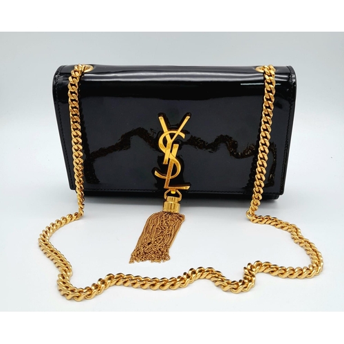 29 - A Saint Laurent 'Kate' Tassel Crossbody Bag. This classic black patent leather bag features a sturdy... 