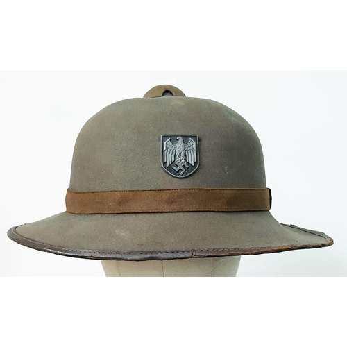 40 - A WW2 2nd Pattern German Africa Corps Pith Helmet with insignia.
