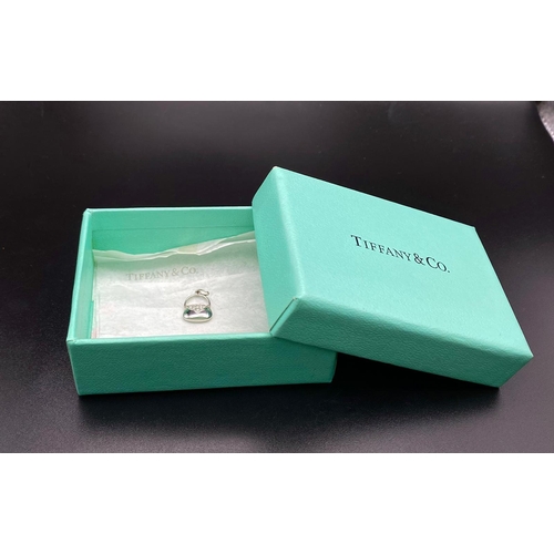 401 - A Tiffany and Co. Diamond and Platinum Handbag Pendant. 
17mm. 2.5g total weight.