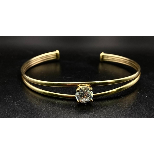 44 - A PRETTY TWIN BAND BANGLE WITH LARGE ZIRCONIA CENTRAL STONE . 4.2gms