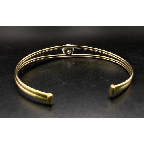 44 - A PRETTY TWIN BAND BANGLE WITH LARGE ZIRCONIA CENTRAL STONE . 4.2gms