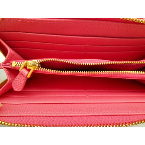 465 - A Prada Pink Bow Purse/Wallet. Saffiano leather exterior. It features two main compartments, a zippe... 