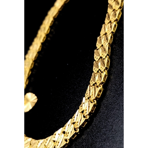 66 - A 22K GOLD ASIAN STYLE BRACELET WITH HEART PENDANT .    11.2gms