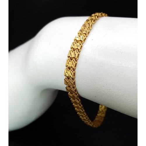 66 - A 22K GOLD ASIAN STYLE BRACELET WITH HEART PENDANT .    11.2gms