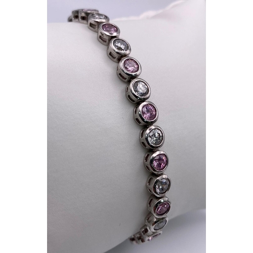 796 - Sterling silver pink and white stone tennis bracelet. Two figure of eight safety catches. Wt 15g.