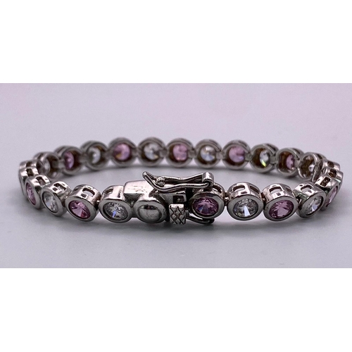 796 - Sterling silver pink and white stone tennis bracelet. Two figure of eight safety catches. Wt 15g.