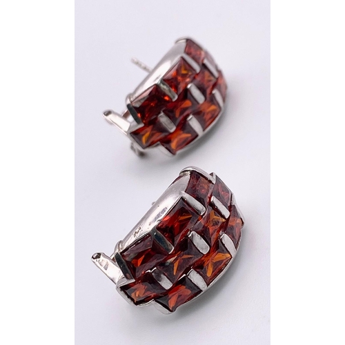 831 - Sterling silver red stone set earrings. Wt 13.1g.