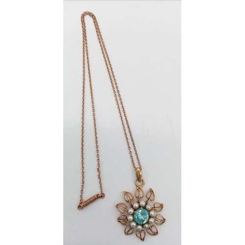 108 - A 9 K rose gold chain necklace with pendant having a floral motif, with a central round cut aquamari... 