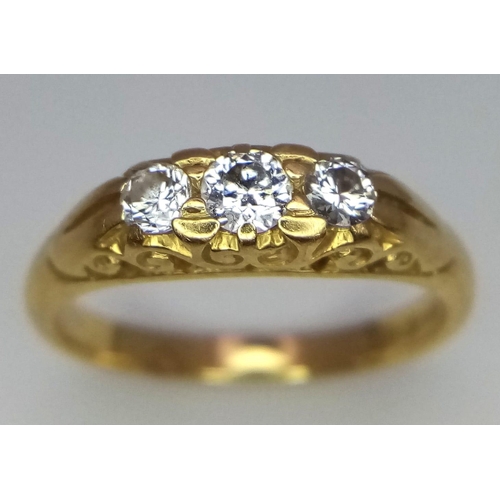 122 - An 18 K yellow gold ring with trilogy of round cut diamonds. Size: M1/2, weight: 3.8 g. 14223