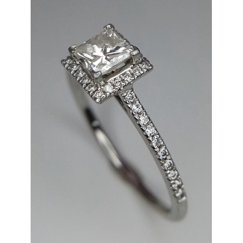 136 - A platinum ring with a princess cut diamond (0.7 carats appr.) and round cut diamonds on the halo an... 