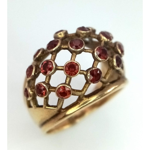 157 - ANTIQUE 9K GOLD RING WITH GARNET STONES SET INTO FILIGREE DESIGNED RING FACE .  5.2gms   size N