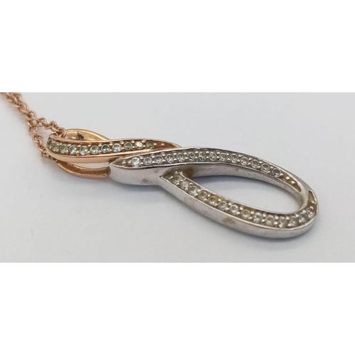 184 - A 9K ROSE AND WHITE GOLD PENDANT WITH DIAMOND ENCRUSTING ON A 46cms 9K ROSE GOLD CHAIN .  3.7gms