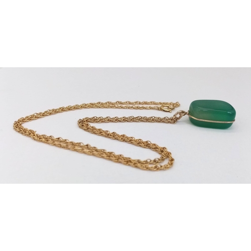 240 - A 50cms 9K GOLD CHAIN WITH A JADE PENDANT .  8.6gms