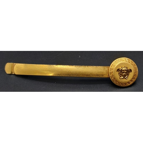 Sold at Auction: A genuine VERSACE gold plated tie holder. Length