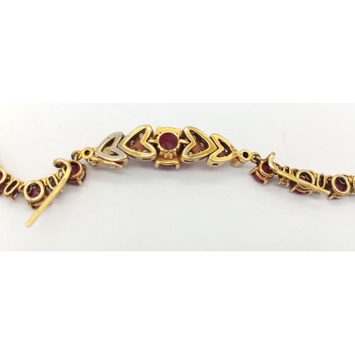 53 - A vintage, 9 K yellow gold necklace loaded with oval cut natural rubies and round cut diamonds. Leng... 