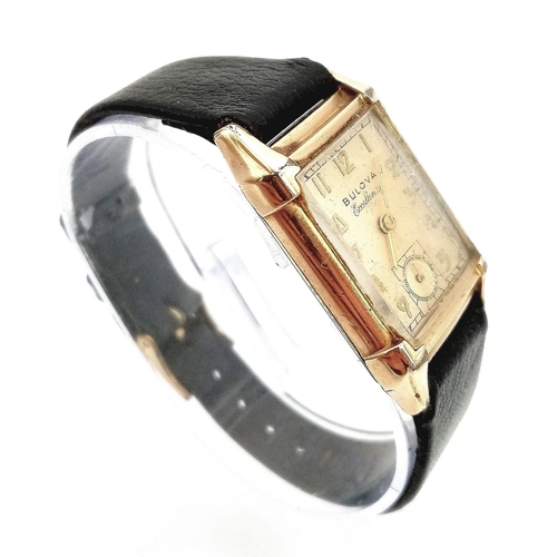 758 - A Vintage Gold Plated Bulova Ladies Tank watch. Black leather strap. Gold plated case - 21mm x 36mm.... 