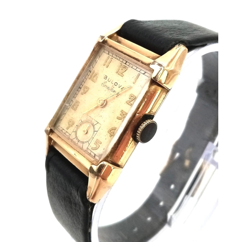 758 - A Vintage Gold Plated Bulova Ladies Tank watch. Black leather strap. Gold plated case - 21mm x 36mm.... 