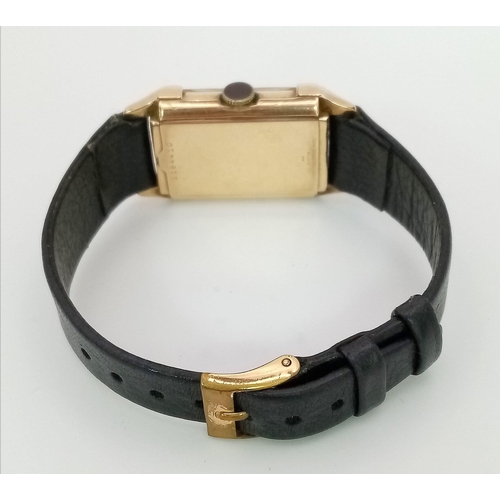 758 - A Vintage Gold Plated Bulova Ladies Tank watch. Black leather strap. Gold plated case - 21mm x 36mm.... 