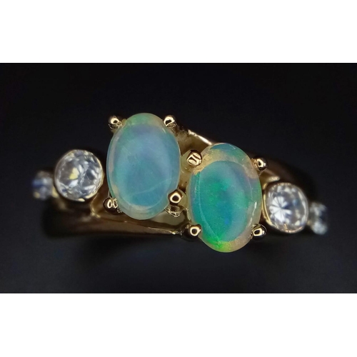 104 - A STYLISH 18K YELLOW GOLD OPAL SET CROSSOVER RING, SET WITH 2 OPALS CENTRE AND FLANKED BY 2 CZ STONE... 