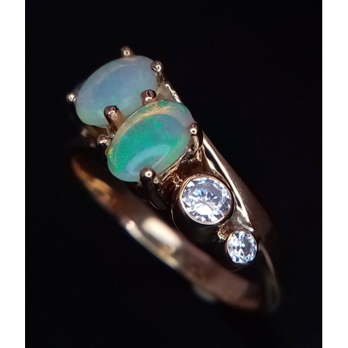 104 - A STYLISH 18K YELLOW GOLD OPAL SET CROSSOVER RING, SET WITH 2 OPALS CENTRE AND FLANKED BY 2 CZ STONE... 