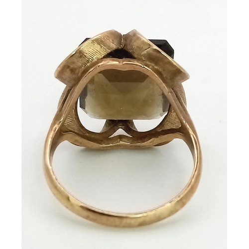 205 - A 9K GOLD DRESS RING WITH SMOKEY QUARTZ CENTRE STONE .  5.3gms   size M