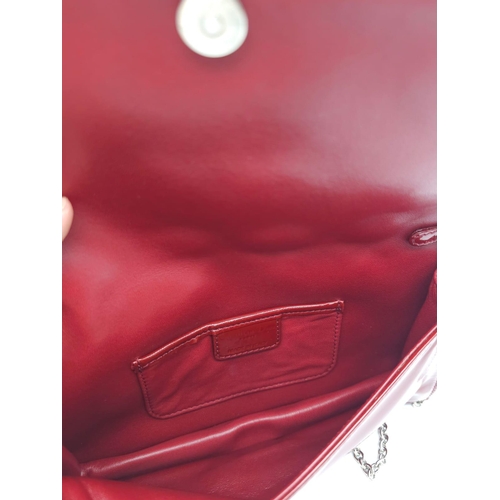 206 - A Christian Dior Red 'Lady Dior' Bag. Cannage quilted patent leather exterior. Magnetic closure, sil... 