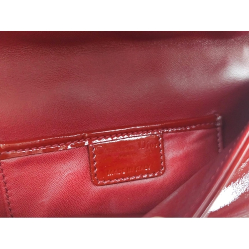 206 - A Christian Dior Red 'Lady Dior' Bag. Cannage quilted patent leather exterior. Magnetic closure, sil... 