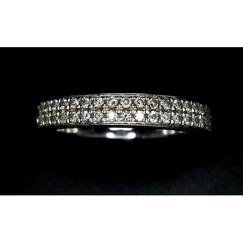 379 - A 9K WHITE GOLD RING WITH ENCRUSTED DIAMOND FRONT .   3.2gms    size M