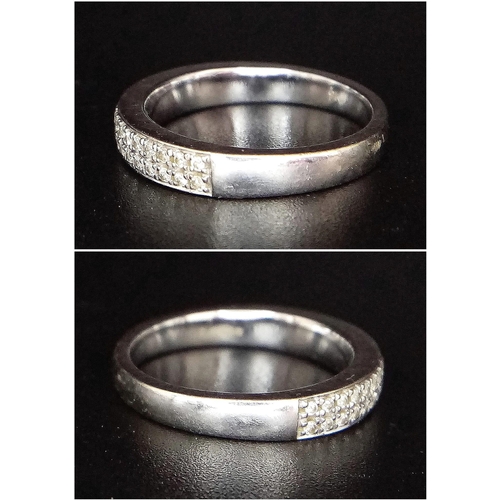 379 - A 9K WHITE GOLD RING WITH ENCRUSTED DIAMOND FRONT .   3.2gms    size M