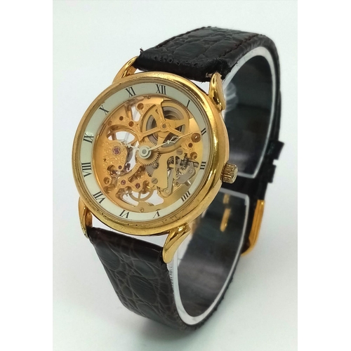 502 - A Benrus Gilded Skeleton Watch. Brown leather strap. Skeleton case - 31mm. In working order.
12018