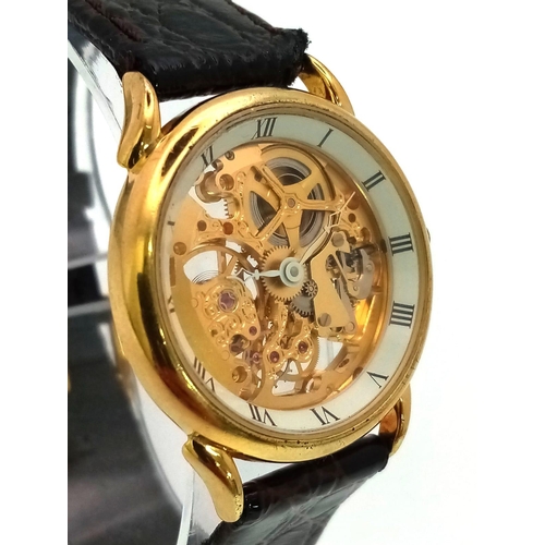 502 - A Benrus Gilded Skeleton Watch. Brown leather strap. Skeleton case - 31mm. In working order.
12018