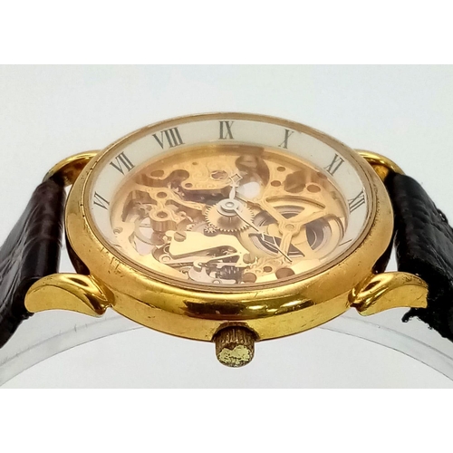 502 - A Benrus Gilded Skeleton Watch. Brown leather strap. Skeleton case - 31mm. In working order.
12018